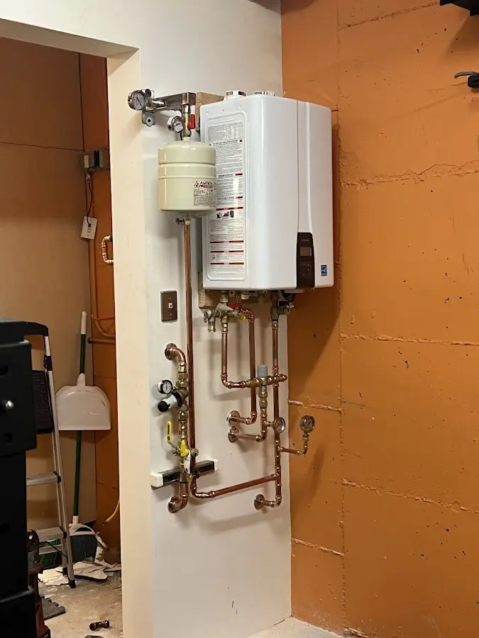 Plumbing technician inspecting water heater connections in Modesto